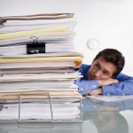 Businessman Overwhelmed with Paperwork